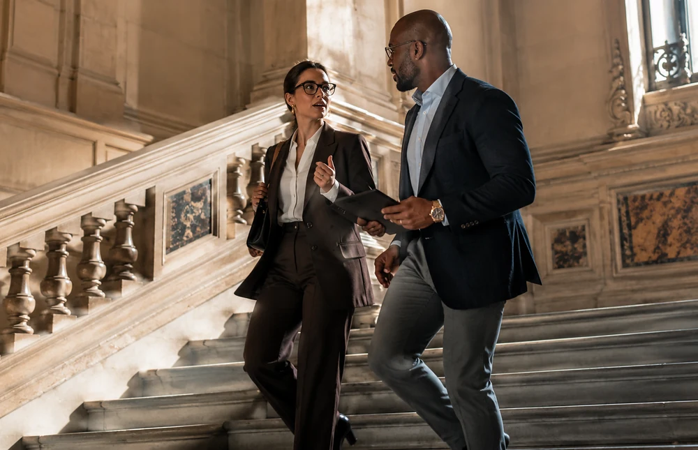 Business professionals moving through an office environment and discussing work